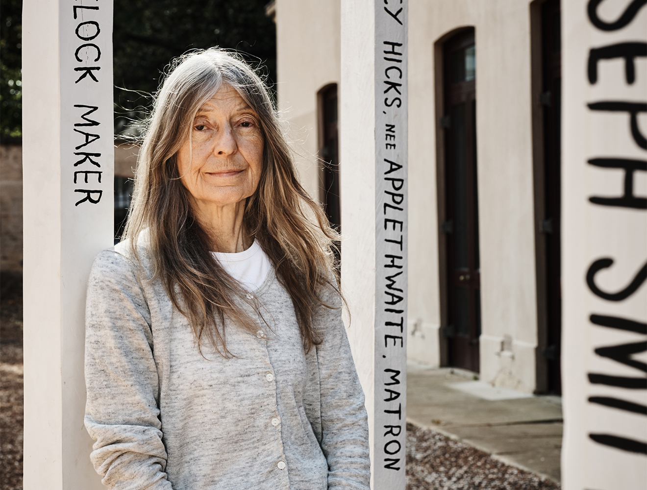 Portrait of Fiona Hall against her installation Who Goes Here? (photograph by Joshua Morris for Sydney Living Museums)